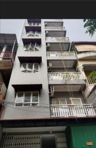 a tall white building with windows and balconies at Ananta Lavender in Phnom Penh