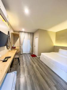 a hotel room with a large bed and a desk at Srikij GardenHome Resort in Sa Kaeo +40 photos