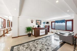 a woman sitting at a desk in a living room at Tiger Sapa hotel in Sa Pa