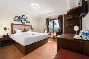 Postel nebo postele na pokoji v ubytování Tiger Sapa hotel
