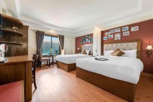 Postel nebo postele na pokoji v ubytování Tiger Sapa hotel + 37 fotografií
