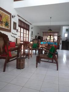 a living room with wooden chairs and tables at Roche's Cozy Corner R-2 Ground Level in Sri Jayewardenepura Kotte