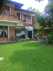a house with a lawn in front of it at Roche's Cozy Corner R-2 Ground Level in Sri Jayewardenepura Kotte +41 photos