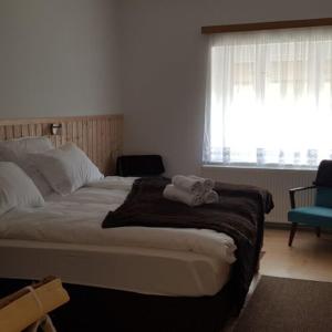 a bedroom with a bed with two towels on it at Hortenzia Vendégház Márianosztra in Márianosztra