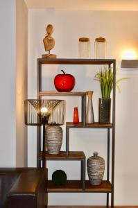 a shelf with vases and an apple on it at Bedford Hotel & Congress Centre in Brussels