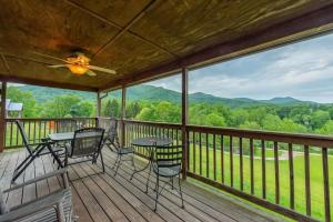 a porch with a table and chairs and mountains at Gorgeous Mountain View Cabin on 12 Acres in Candler