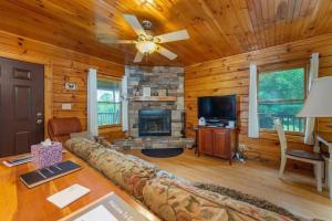 a living room with a couch and a fireplace at Gorgeous Mountain View Cabin on 12 Acres in Candler