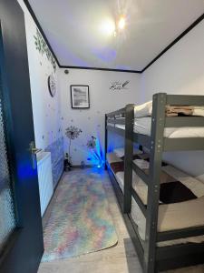 a bunk bed room with two bunk beds and a hallway at Le Clos fleuri in Fauvillers