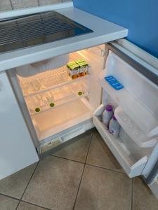 an empty refrigerator with its door open in a kitchen at Villa Vittoria in Matera +71 photos