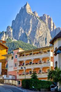 a hotel with a mountain in the background at Eden Apartments in Siusi