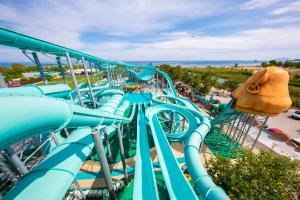 a water park with a blue roller coaster at Daima Biz Hotel - Dolusu Aquapark Access in Kemer