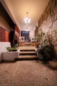 a building with stairs and a stone wall at BYOC Hostels in Bangalore