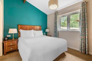 a bedroom with a large bed and a window at Wychnor Park Country Club in Barton under Needwood