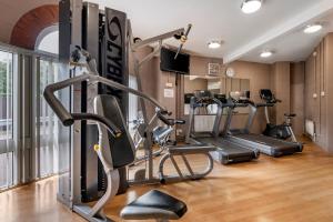 a gym with treadmills and elliptical machines at Wychnor Park Country Club in Barton under Needwood