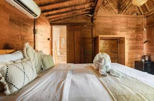 a bedroom with a bed with a stuffed animal on it at Pondok chesia homestay in Canggu