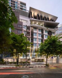 a tall building with a street in front of it at Samyan Serene Hotel in Bangkok