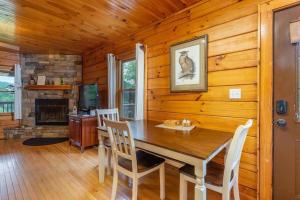 a dining room with a table and chairs in a cabin at Gorgeous Mountain View Cabin on 12 Acres in Candler