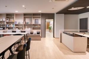 a restaurant with tables and chairs and a waiting room at Samyan Serene Hotel in Bangkok
