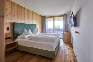 Ένα ή περισσότερα κρεβάτια σε δωμάτιο στο Mountain Lodge Margit