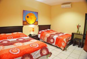 מיטה או מיטות בחדר ב-Hotel Plaza Cosiguina