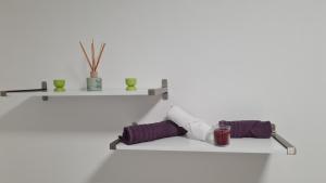 a shelf with two purple pillows and a candle at Apartman "Britanac" in Zagreb