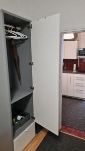 a closet with a door open in a kitchen at Apartman "Britanac" in Zagreb +19 photos