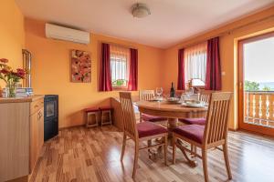una cucina e una sala da pranzo con tavolo e sedie di Vineyard Cottage Pyramid - Happy Rentals a Dobrnič