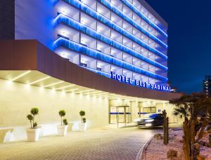 a car drives past the hotel festival hall at night at Hotel Best Sabinal in Roquetas de Mar