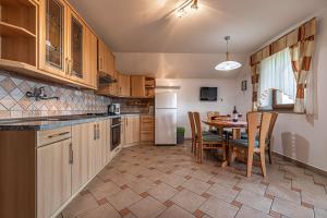 a kitchen with a table and a dining room at Vineyard Cottage Ucman - Happy Rentals in Otočec