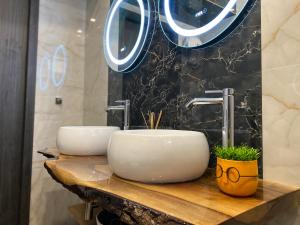 two sinks on a wooden counter in a bathroom at La Luna - High-end 2BD Flat in the TOP centre by Flat Mаnager in Sofia