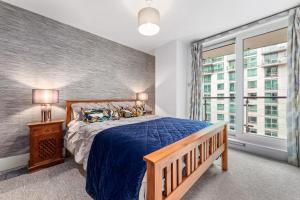 a bedroom with a bed and a large window at St, George Wharf Vauxhall Bridge large 2Bedrooms apartment with River View panoramic balcony in London