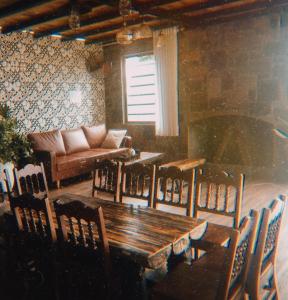 a living room with a wooden table and a couch at Bách Xanh House Venuestay in Vĩnh Phúc