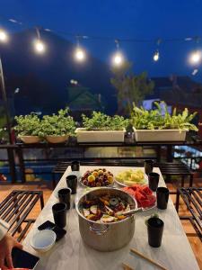 a table with a buffet of food on a balcony at Bách Xanh House Venuestay in Vĩnh Phúc