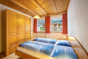 a bedroom with a bed and a window at Kuenz Dolomites App Drau in San Candido