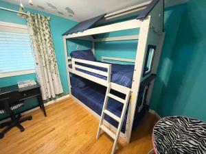 a bedroom with two bunk beds and a desk at Gorgeous Home w Pool & Hot Tub in Schenectady