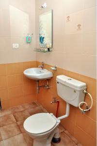 a bathroom with a toilet and a sink at Cozy Haven Luxury Holiday Home in Majorda