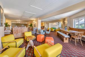 a waiting room with colorful chairs and tables at Woodford Bridge Country Club in Milton Damerel