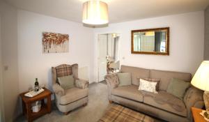 a living room with a couch and a chair at 2 Bed House - Large Garden - Fully Refurbished in Ashington