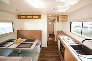 a small kitchen with a stove and a sink at Hausboot in Hennigsdorf