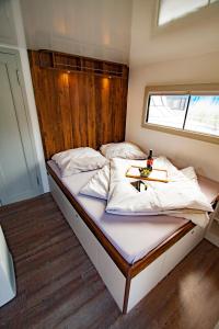 a bedroom with a bed with a tray on it at Hausboot in Hennigsdorf