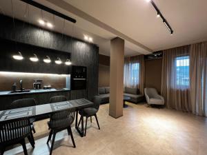a kitchen with a table and chairs in a room at Apart leitmotif in Tbilisi City