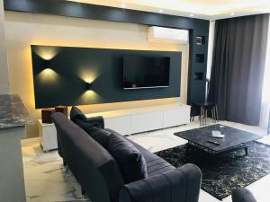 a living room with a couch and a flat screen tv at Sapanca Villa View Suite in Sapanca