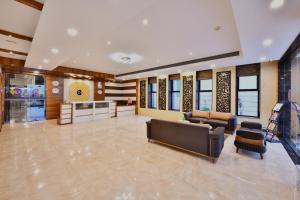 a large lobby with couches and chairs and windows at Click Hotel Sagar Plaza Chakan, Pune in Chakan