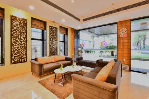 a living room with couches and a table at Click Hotel Sagar Plaza Chakan, Pune in Chakan