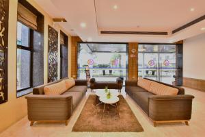 a living room with two couches and a table at Click Hotel Sagar Plaza Chakan, Pune in Chakan