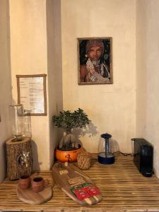 a table with a picture of a woman on the wall at IL CAMPO Ecolodge & Boutique Hotel in Cairo