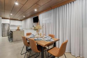 a dining room with a table and chairs at Railway Motel Myrtleford in Myrtleford