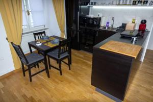 a kitchen with a table and two chairs and a counter at Studio MAYA in Maribor