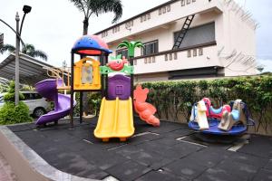 a group of playground equipment in front of a building at Click Hotel Sagar Plaza Chakan, Pune in Chakan