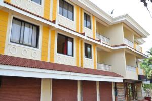 a building with yellow and red accents at Cozy Haven Luxury Holiday Home in Majorda